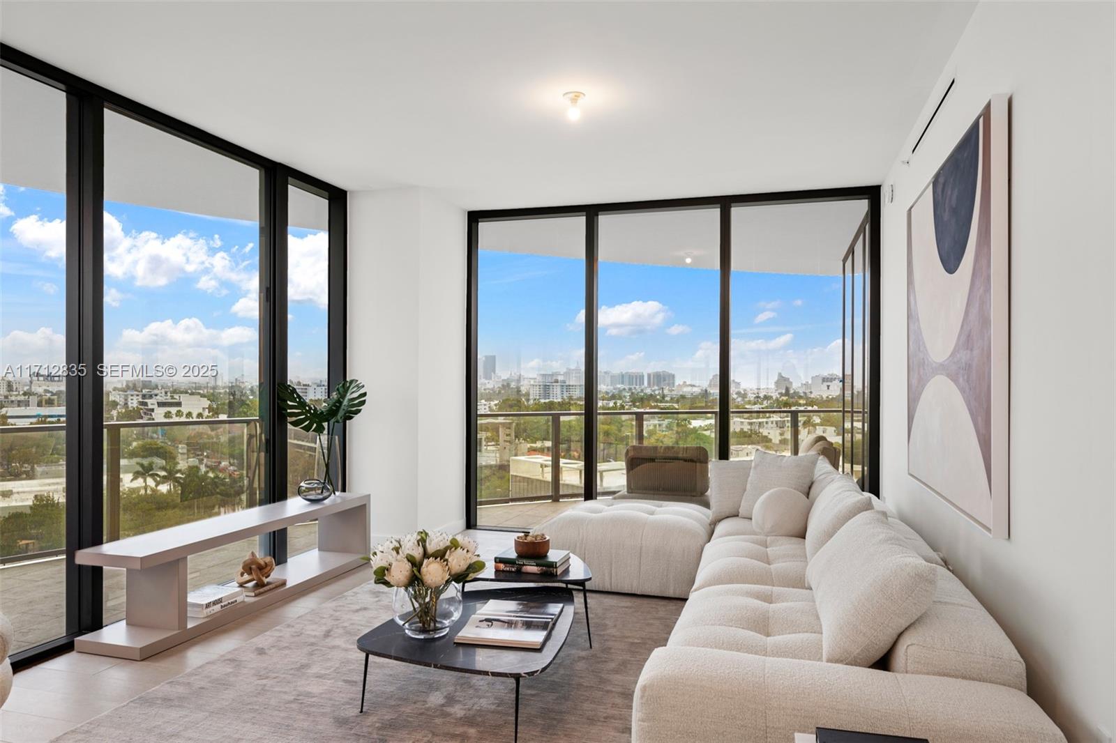 500 Alton Road, Unit 1005 Miami Beach, FL 33139 - Photo 2 of 49 a living room with furniture and floor to ceiling windows