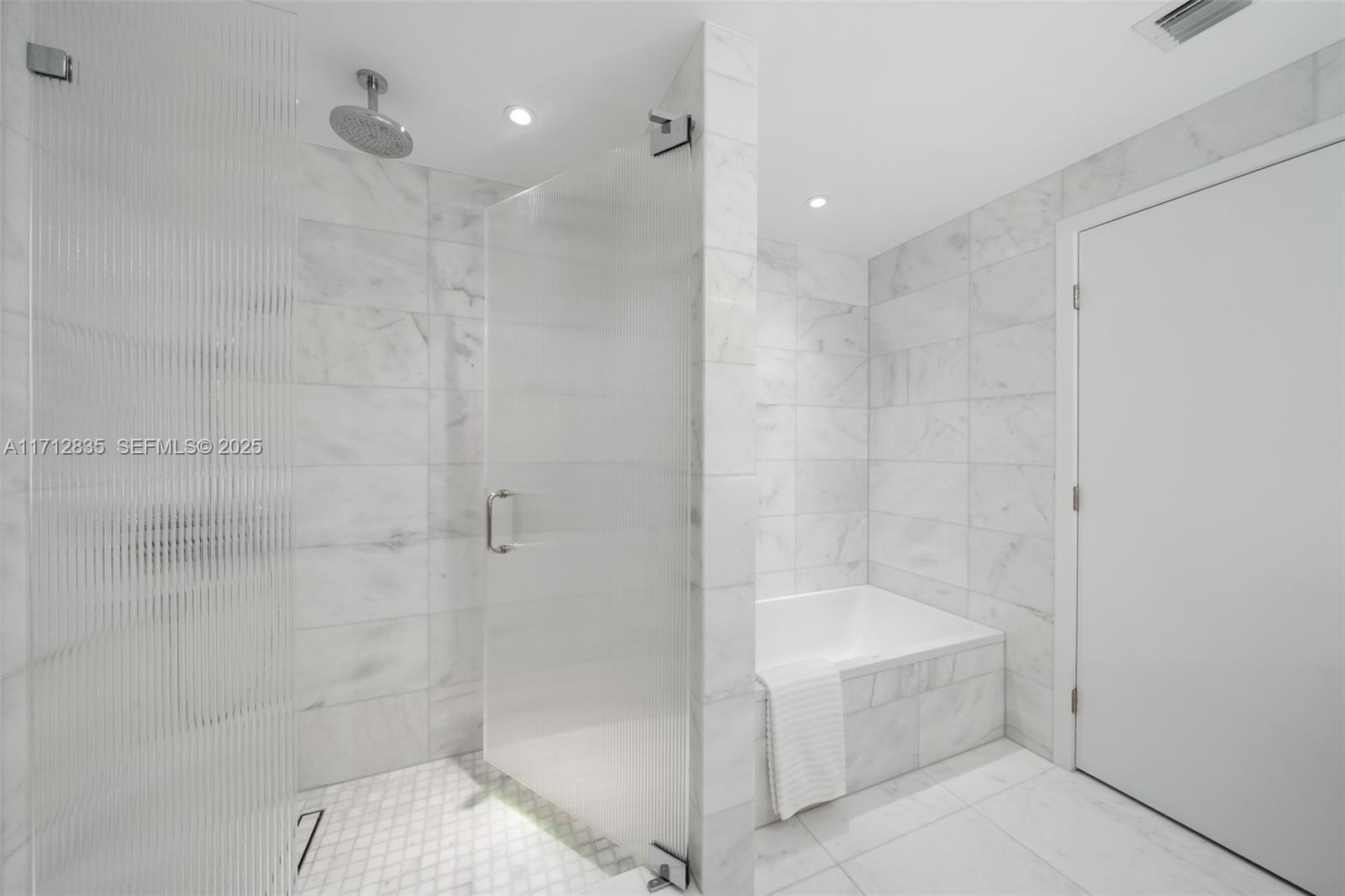 500 Alton Road, Unit 1005 Miami Beach, FL 33139 - Photo 24 of 49 a bathroom with a bathtub and shower