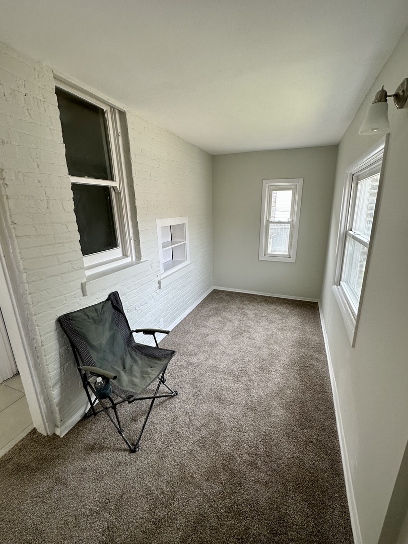 7828 South Carpenter Street Chicago, IL 60620 - Photo 11 of 18 a living room with furniture and a window
