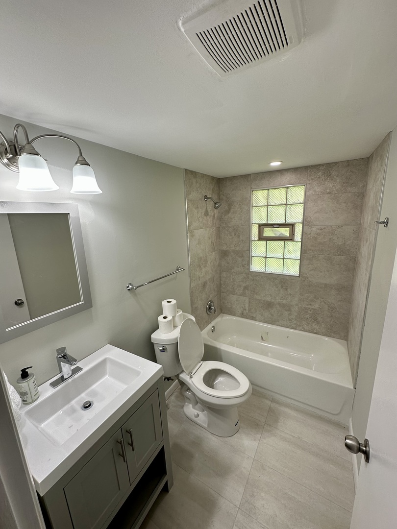 7828 South Carpenter Street Chicago, IL 60620 - Photo 14 of 18 a bathroom with a sink a toilet and shower