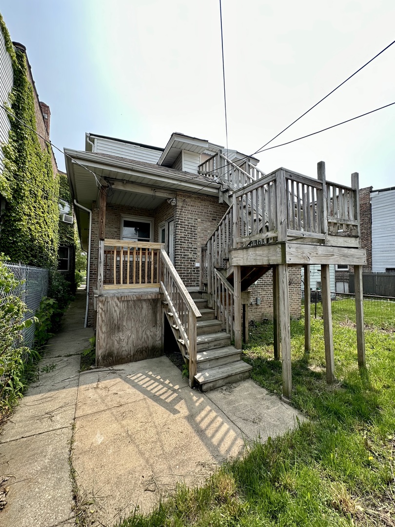 7828 South Carpenter Street Chicago, IL 60620 - Photo 16 of 18 a front view of a house with a yard