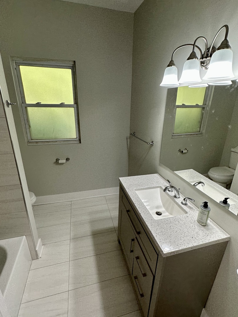 7828 South Carpenter Street Chicago, IL 60620 - Photo 4 of 18 a bathroom with a sink and a mirror