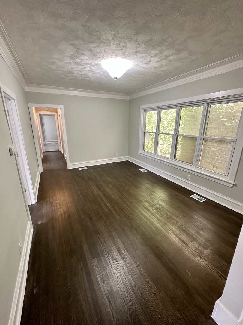 7828 South Carpenter Street Chicago, IL 60620 - Photo 9 of 18 wooden floor in an empty room with a window