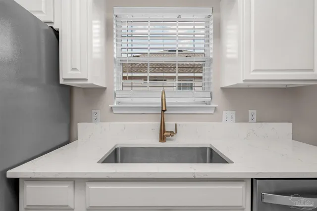 a kitchen with cabinets and stainless steel appliances
