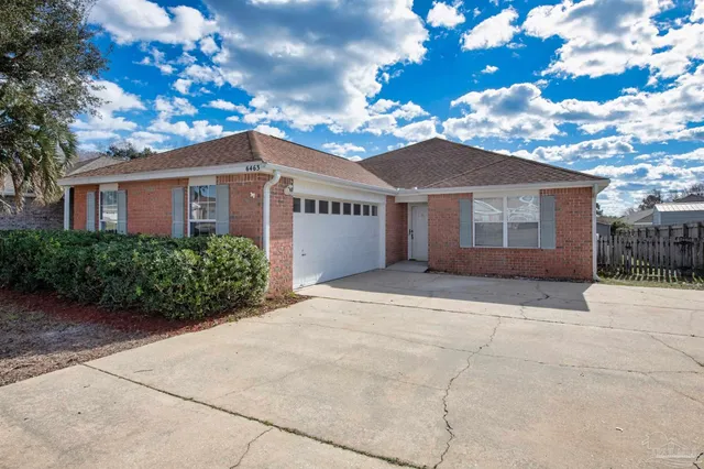 a view of a house with a yard and potted plants