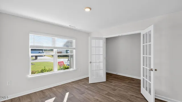wooden floor in an empty room with a window