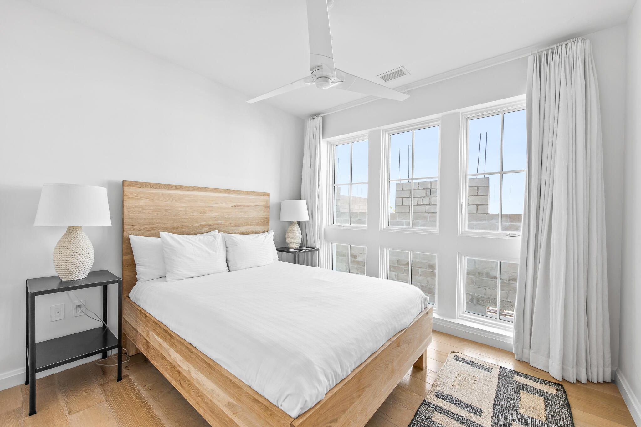 74 Governors Ct Inlet Beach, Unit 304 Inlet Beach, FL 32461 - Photo 14 of 39 a bedroom with a bed and large window