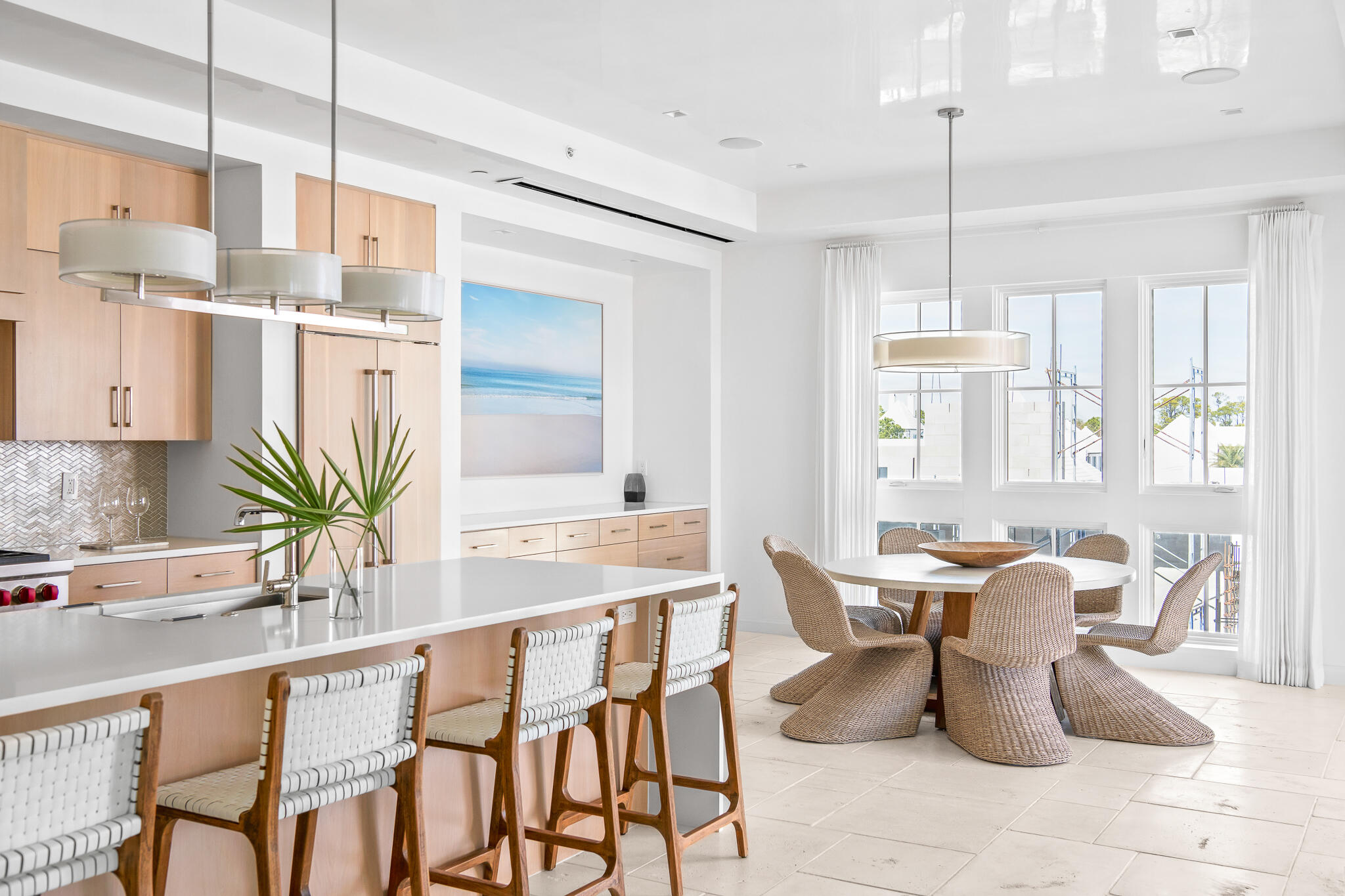 74 Governors Ct Inlet Beach, Unit 304 Inlet Beach, FL 32461 - Photo 6 of 39 a kitchen with stainless steel appliances kitchen island granite countertop a table chairs in it and wooden floors