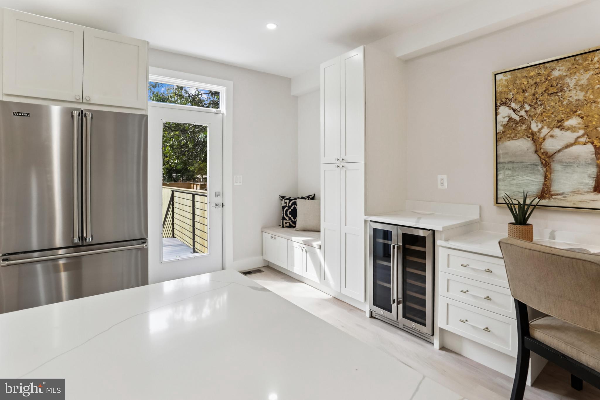 208 Webster Street Northwest Washington, DC 20011 - Photo 14 of 46 a spacious bedroom with a balcony a bed and a refrigerator