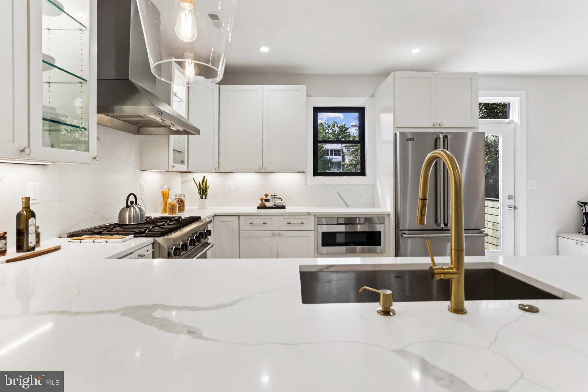 208 Webster Street Northwest Washington, DC 20011 - Photo 15 of 46 a kitchen with stainless steel appliances kitchen island a stove a sink and a white cabinets