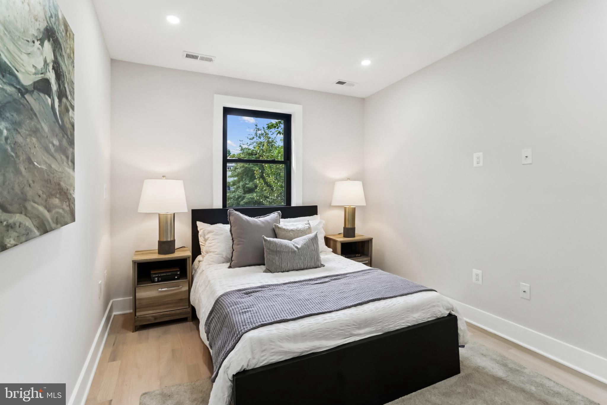 208 Webster Street Northwest Washington, DC 20011 - Photo 23 of 46 a bedroom with a bed and a lamp