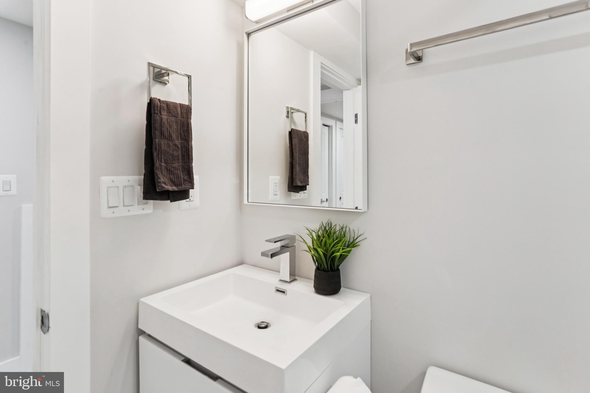 208 Webster Street Northwest Washington, DC 20011 - Photo 40 of 46 a bathroom with a sink a mirror and shower