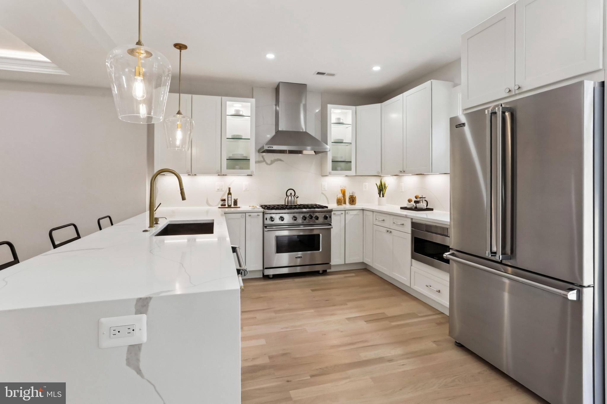 208 Webster Street Northwest Washington, DC 20011 - Photo 8 of 46 a kitchen with kitchen island a counter top space a sink stainless steel appliances and cabinets