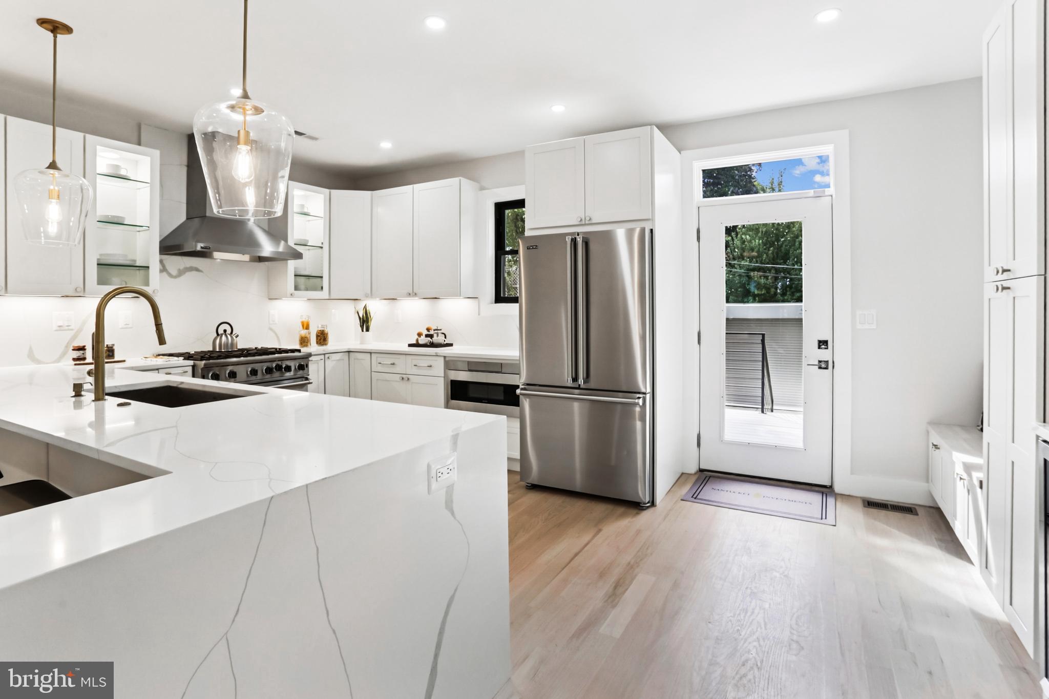 208 Webster Street Northwest Washington, DC 20011 - Photo 10 of 46 a kitchen with stainless steel appliances a refrigerator sink and wooden floor