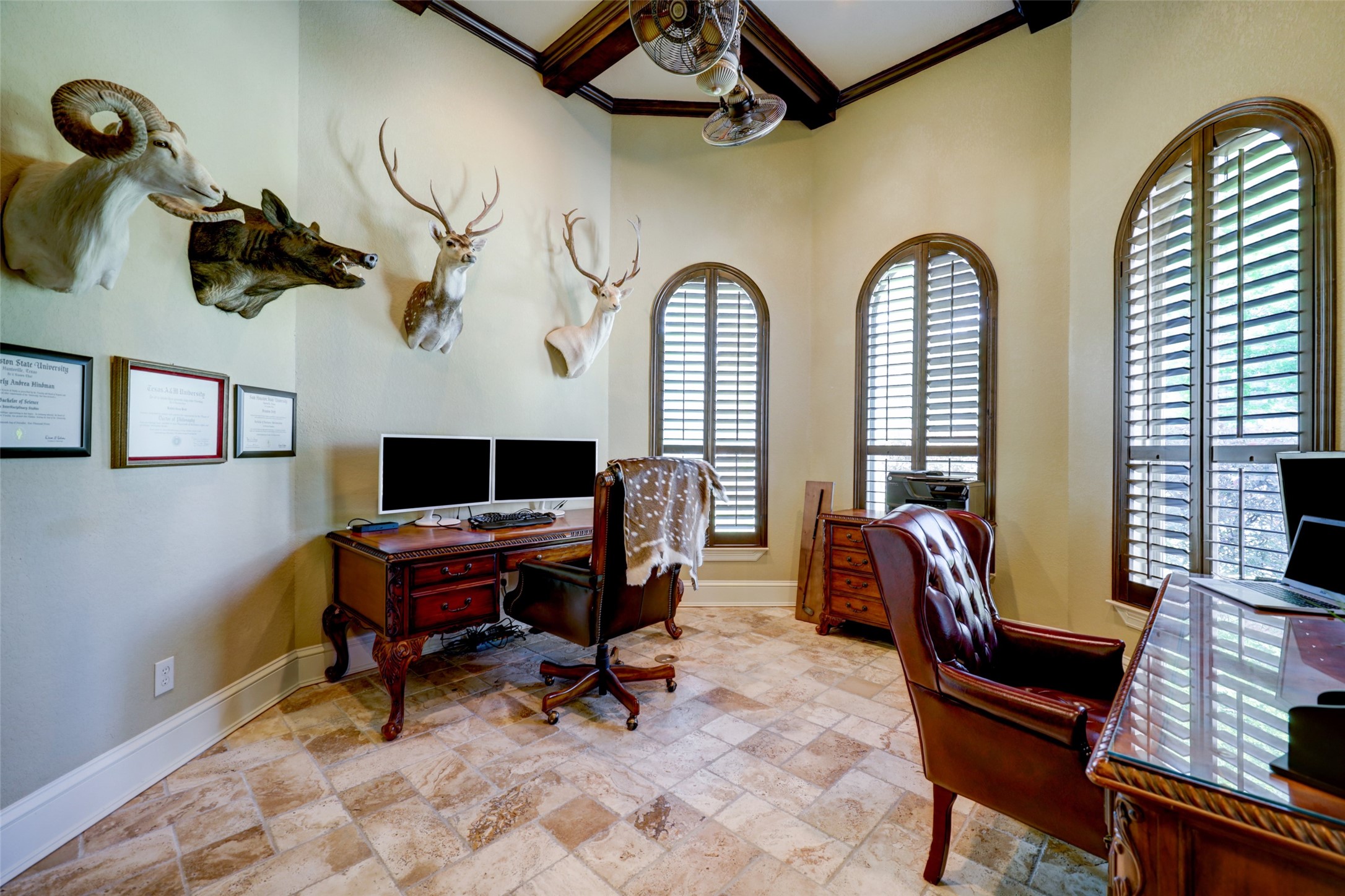 4434 Chateau Creek Way Spring, TX 77386 - Photo 11 of 34 This is a sophisticated home office featuring high ceilings with wooden beams, elegant arched windows with shutters, ideal for a quiet and focused workspace.