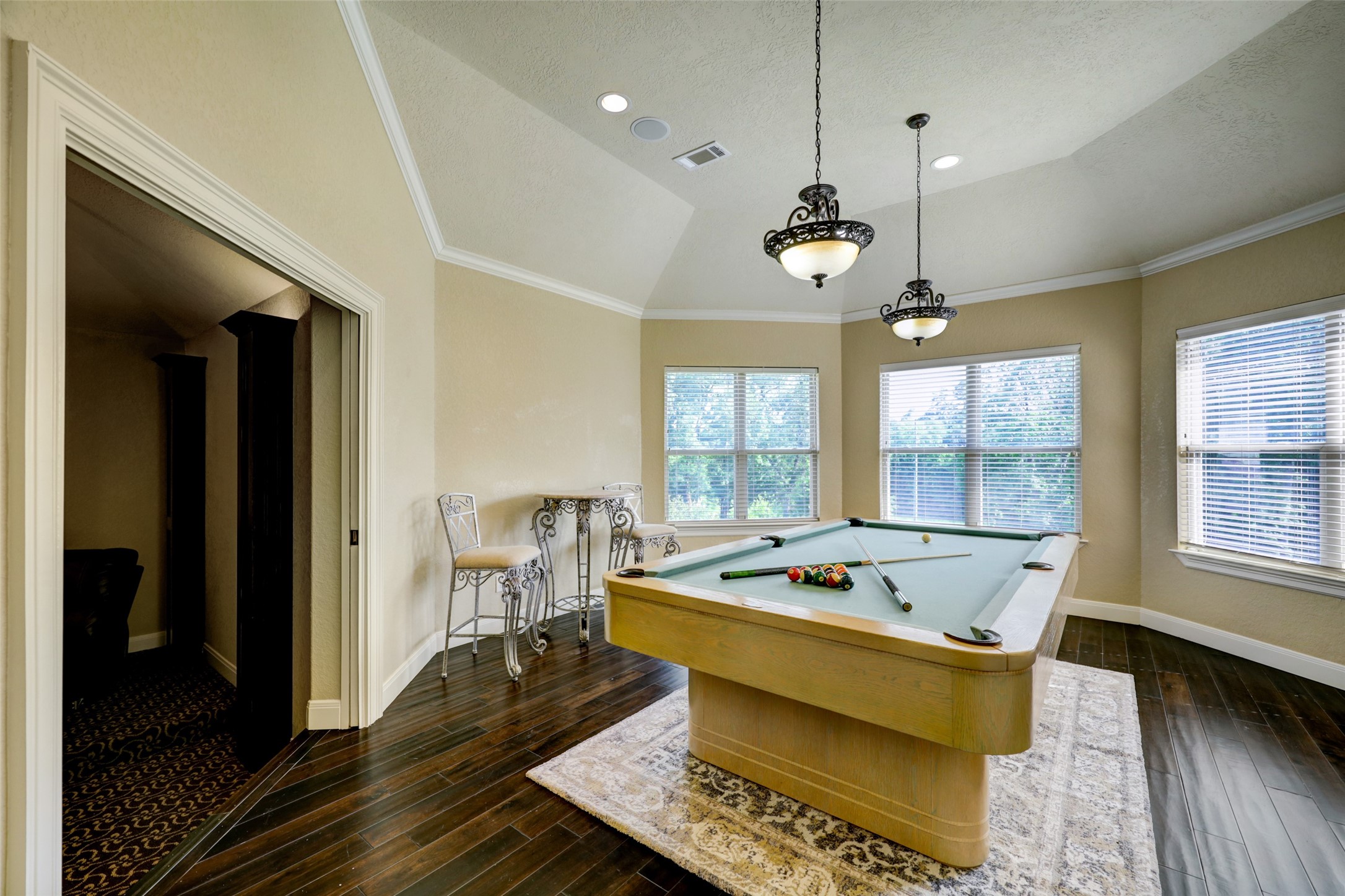 4434 Chateau Creek Way Spring, TX 77386 - Photo 27 of 34 Featured is the upstairs game room with views of the backyard swimming pool and access to the media room.