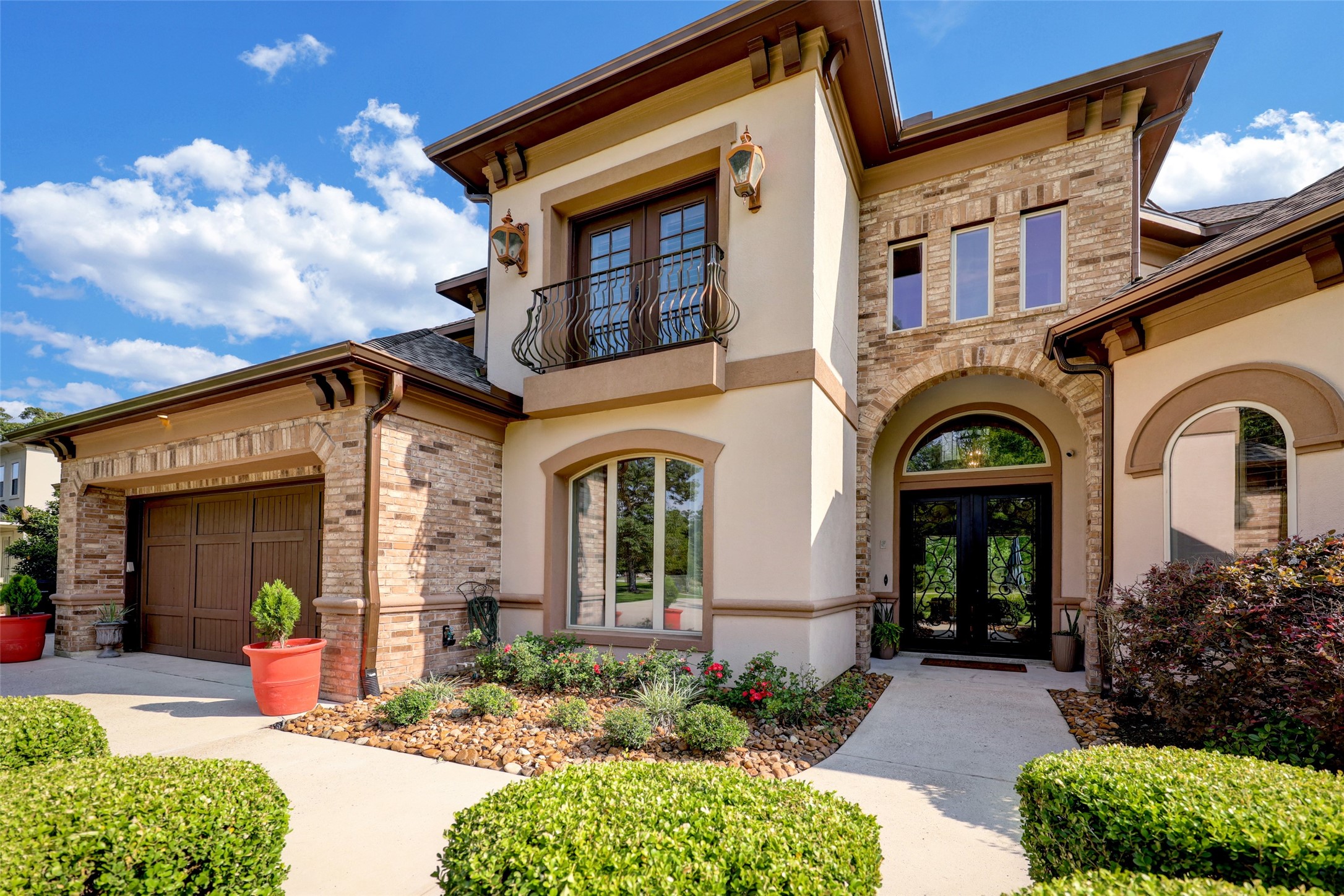 4434 Chateau Creek Way Spring, TX 77386 - Photo 8 of 34 The entryway is highlighted by a charming arched doorway, while well-maintained landscaping and a spacious driveway enhance its curb appeal.