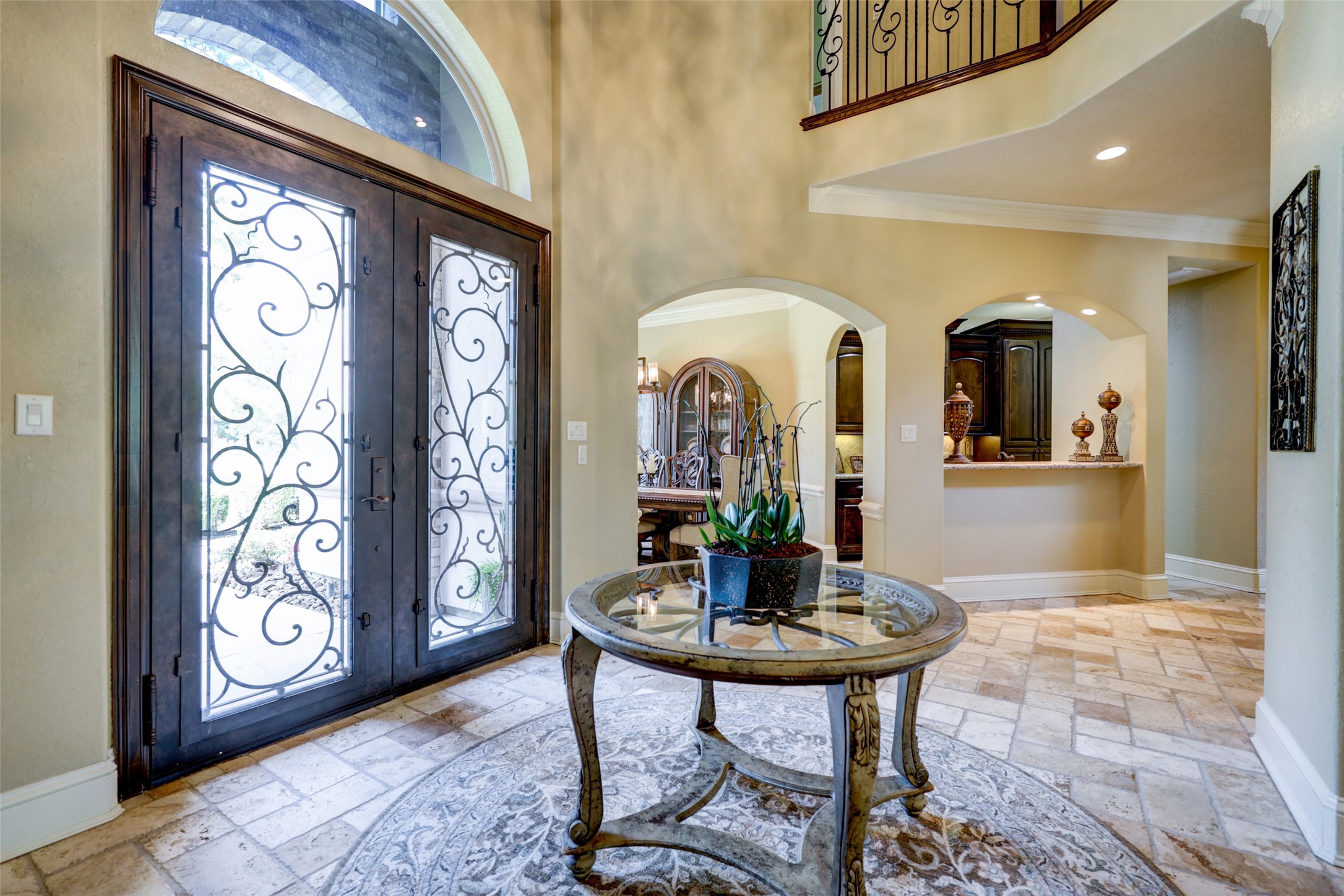 4434 Chateau Creek Way Spring, TX 77386 - Photo 10 of 34 This elegant entryway features ornate double doors with ironwork and a view into an adjoining dining area. The space is bright with high ceilings and a great way to greet guests.