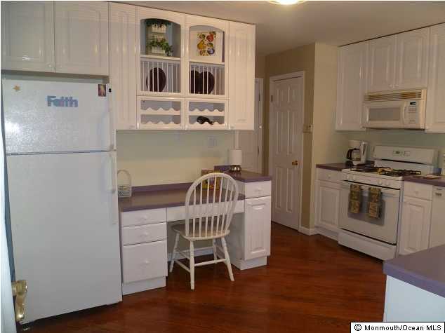 727 Midstreams Road Brick, NJ 08724 - Photo 1 of 3 a kitchen with stainless steel appliances a refrigerator a stove a sink and white cabinets with wooden floor