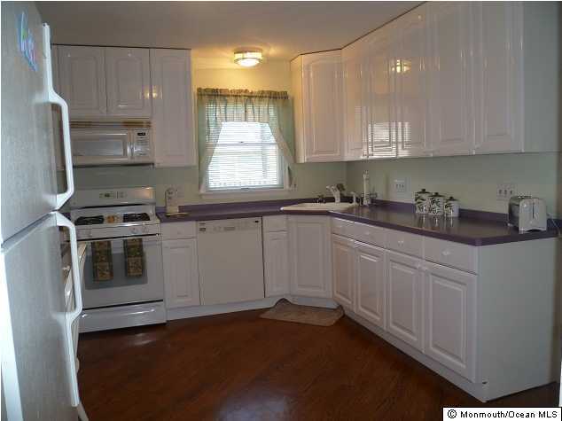 727 Midstreams Road Brick, NJ 08724 - Photo 2 of 3 a kitchen with a sink stove and microwave