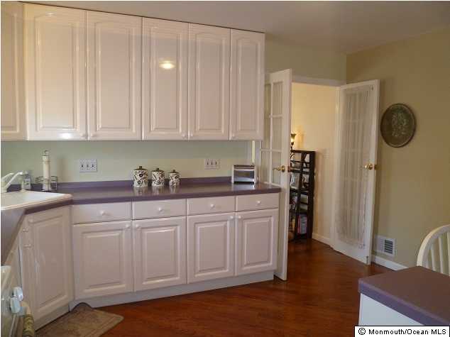 727 Midstreams Road Brick, NJ 08724 - Photo 3 of 3 a kitchen with stainless steel appliances granite countertop a refrigerator sink and cabinets