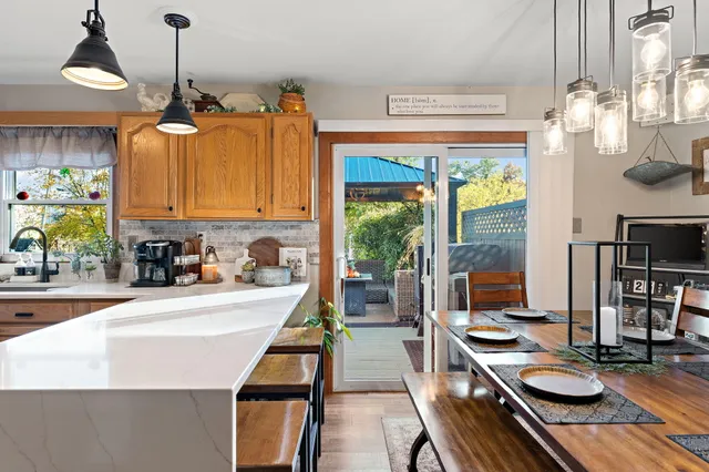 a kitchen with sink refrigerator and stove top oven