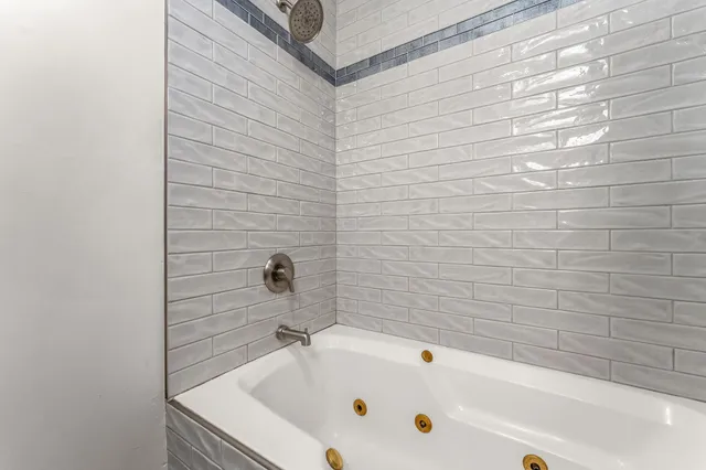 a bathroom with a white bathtub