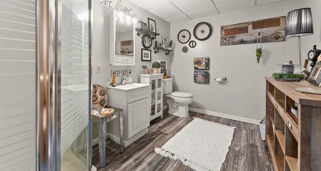 a bathroom with a sink a toilet and a mirror