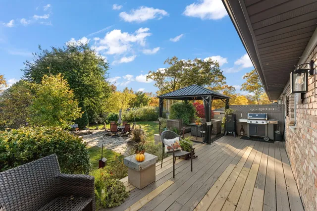 a view of a chairs and table on the wooden deck
