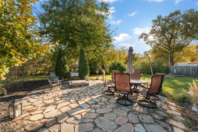 a view of a backyard with sitting area