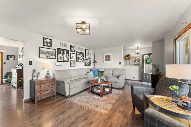 a living room with furniture and wooden floor