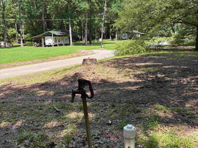 a view of a house with a yard and sitting area