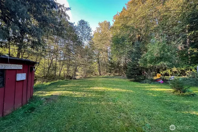 a view of a wooden house and a yard