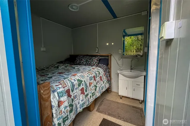 a bedroom with a bed and a window