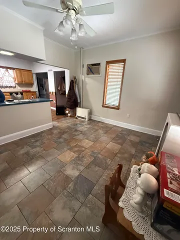 a view of an empty room with furniture and a ceiling fan