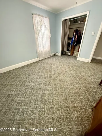 a view of empty room with closet