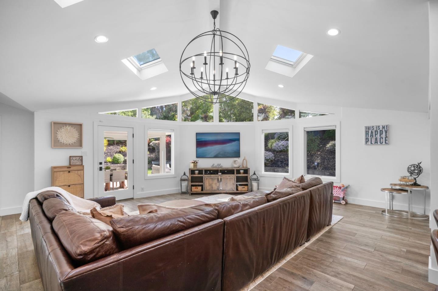 575 Darrell Road Hillsborough, CA 94010 - Photo 15 of 75 a living room with furniture a chandelier and a dining table