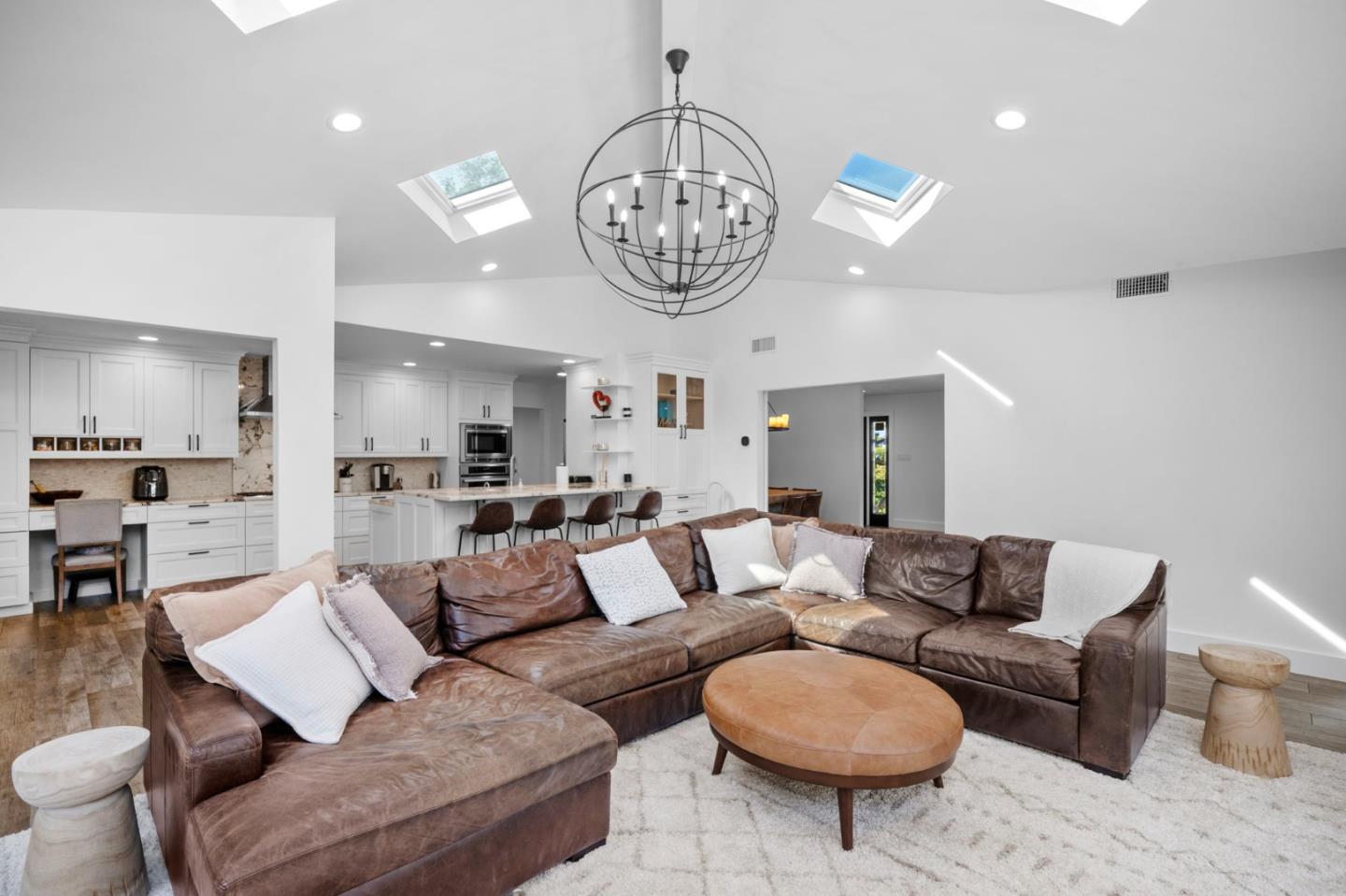 575 Darrell Road Hillsborough, CA 94010 - Photo 18 of 75 a living room with furniture a fireplace and a chandelier