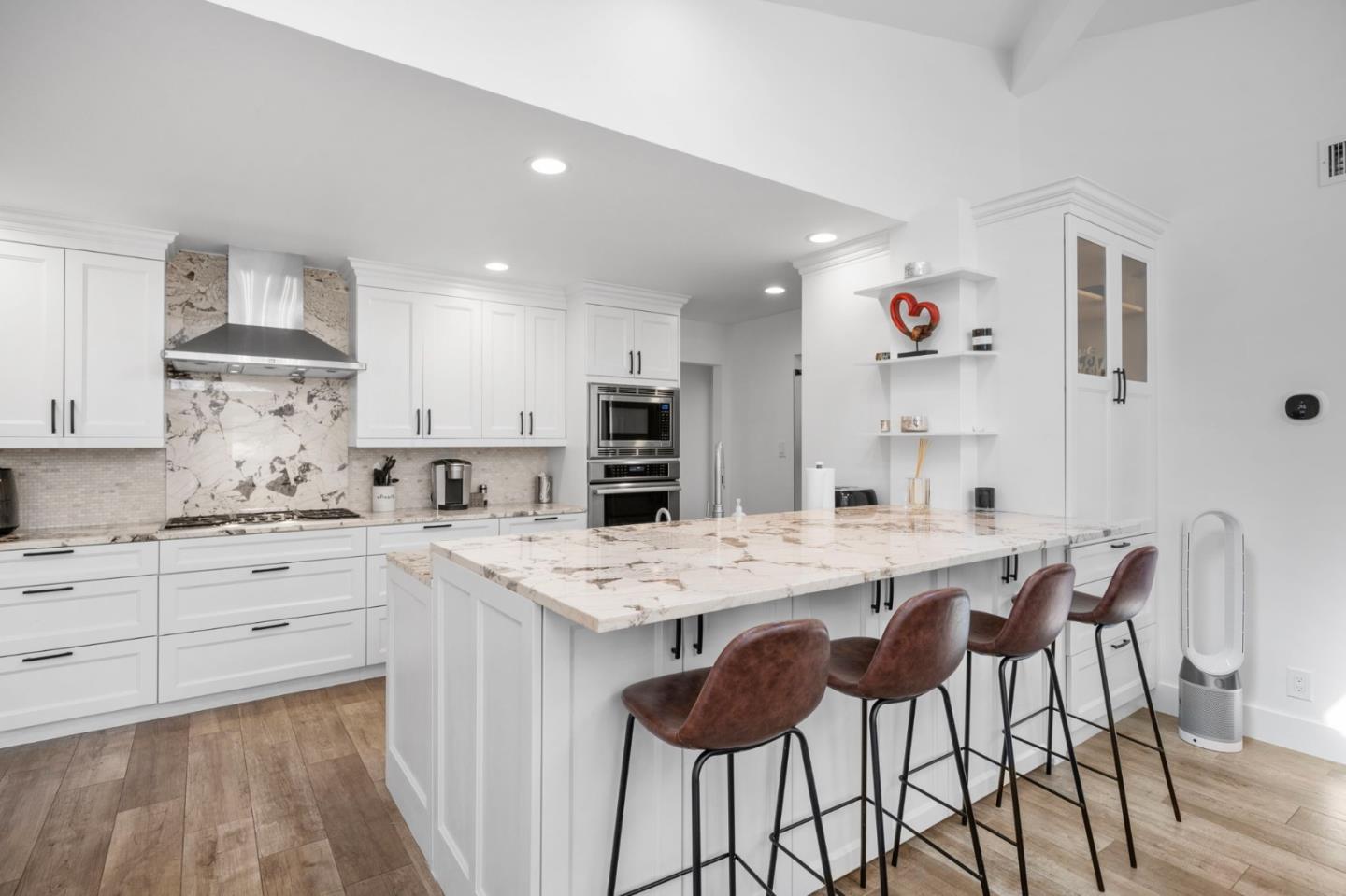 575 Darrell Road Hillsborough, CA 94010 - Photo 20 of 75 a kitchen with stainless steel appliances kitchen island granite countertop a table chairs sink and cabinets