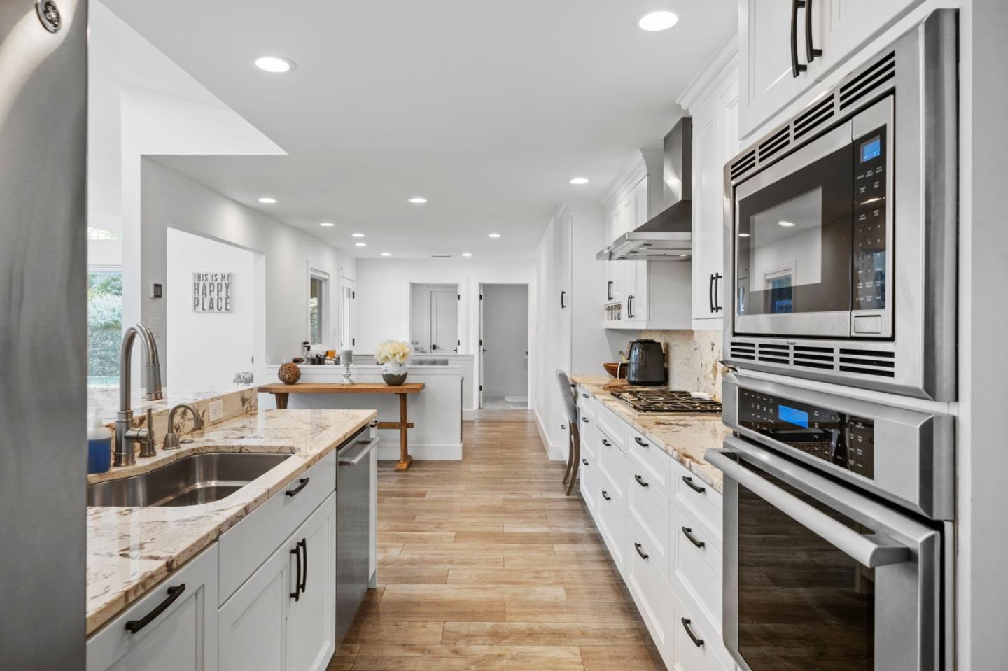 575 Darrell Road Hillsborough, CA 94010 - Photo 26 of 75 a large kitchen with stainless steel appliances kitchen island granite countertop a sink and cabinets