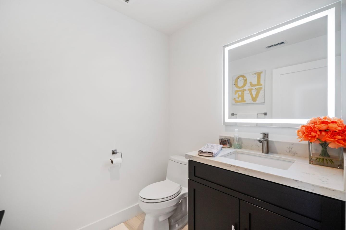 575 Darrell Road Hillsborough, CA 94010 - Photo 31 of 75 a bathroom with a sink vanity mirror and toilet