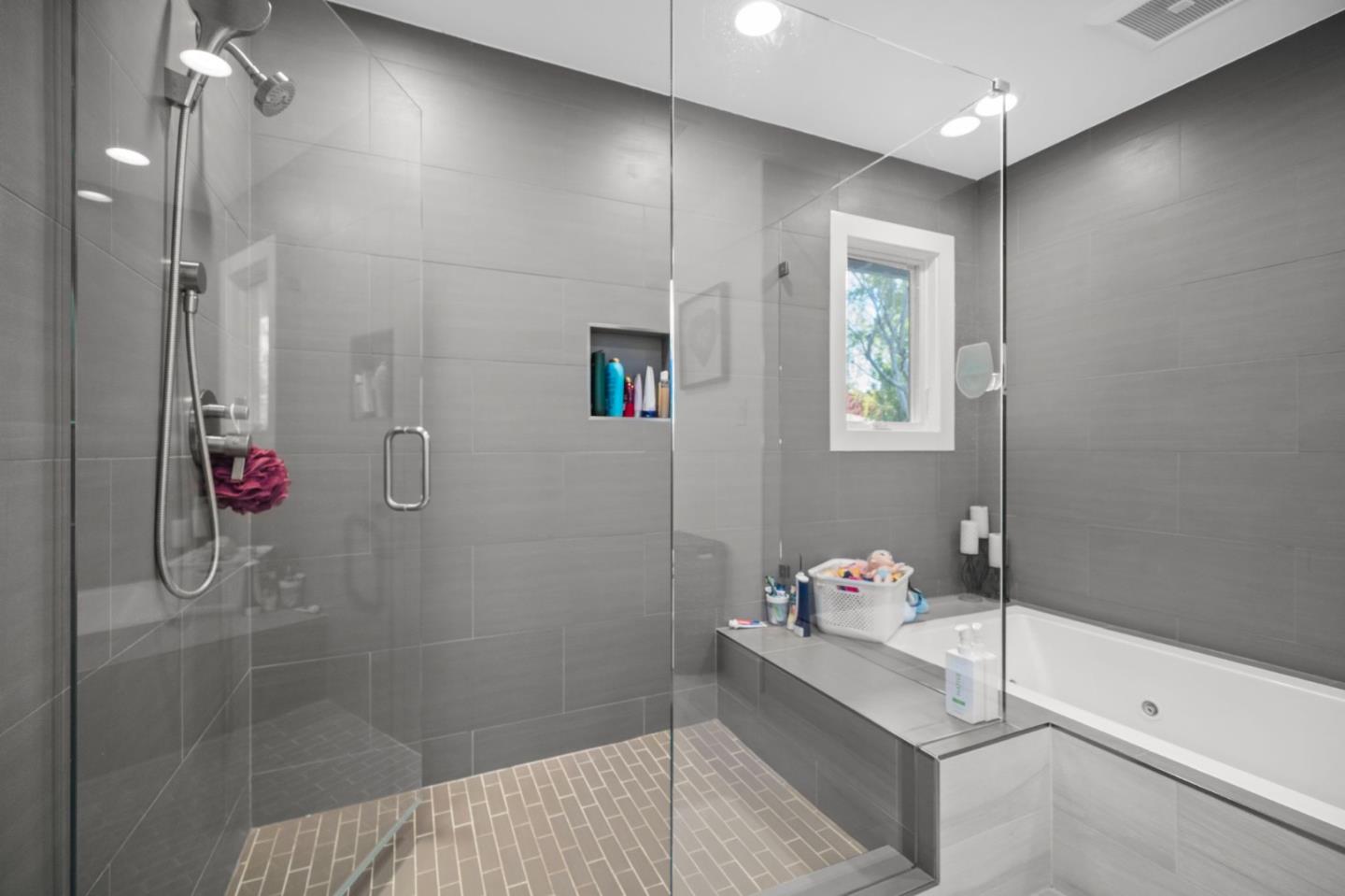 575 Darrell Road Hillsborough, CA 94010 - Photo 37 of 75 a bathroom with a tub shower and mirror