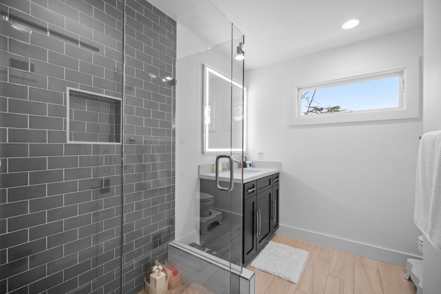 575 Darrell Road Hillsborough, CA 94010 - Photo 49 of 75 a bathroom with a granite countertop sink a mirror and shower