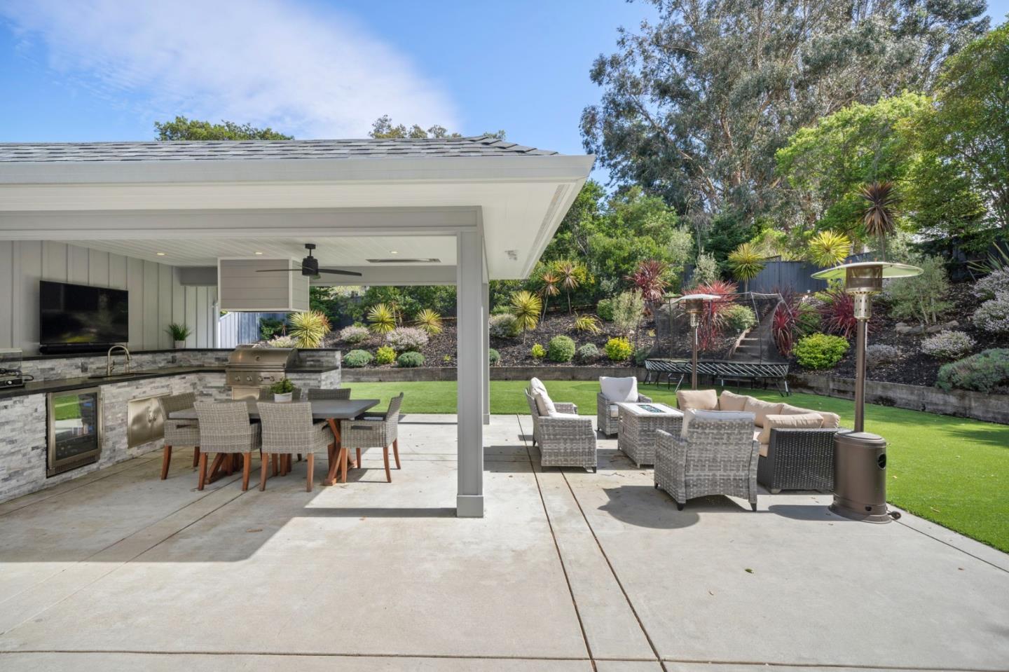 575 Darrell Road Hillsborough, CA 94010 - Photo 61 of 75 a view of a patio with dining table and chairs with a barbeque grill and plants