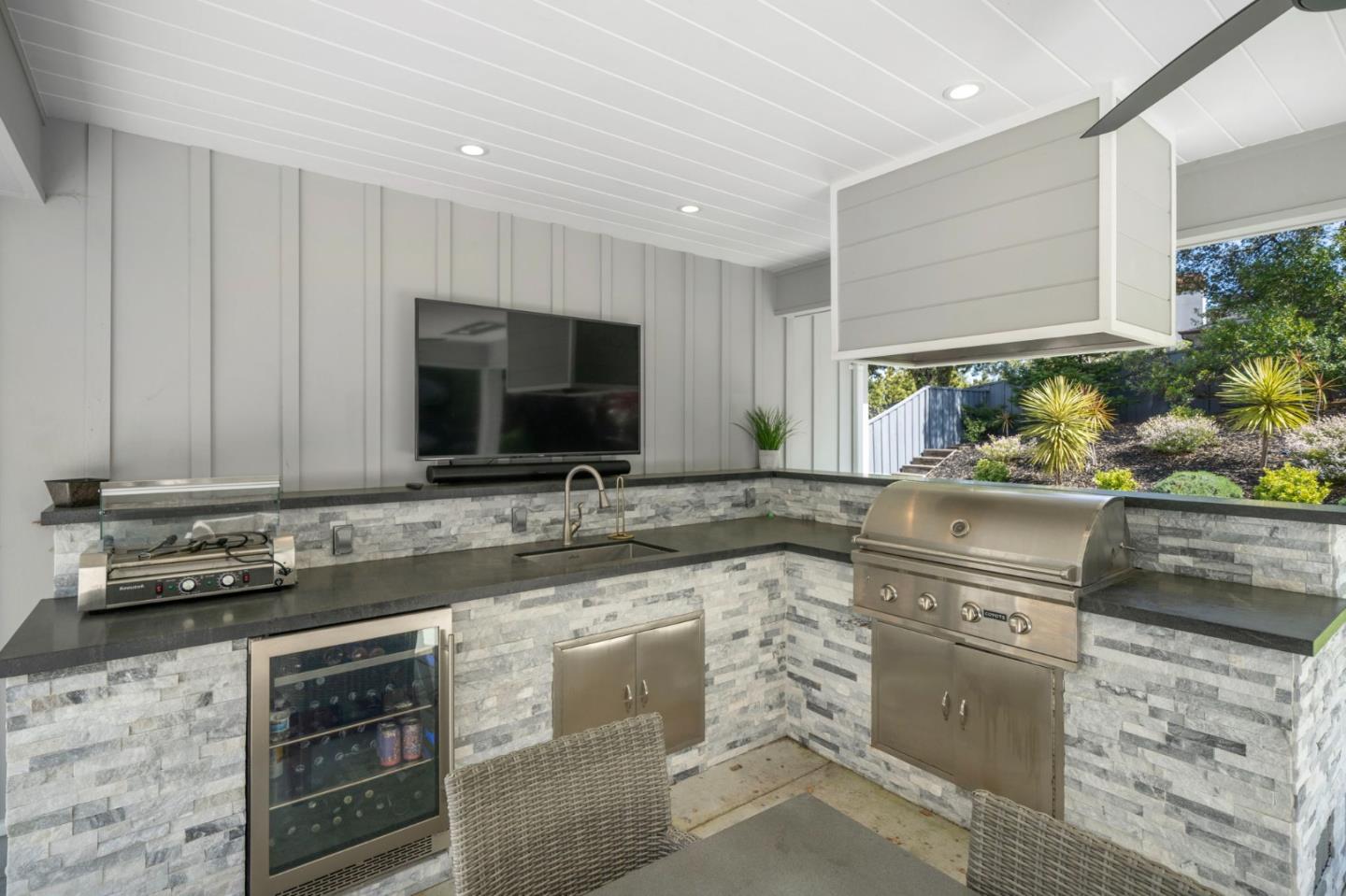 575 Darrell Road Hillsborough, CA 94010 - Photo 63 of 75 a kitchen with stainless steel appliances granite countertop a sink and a stove