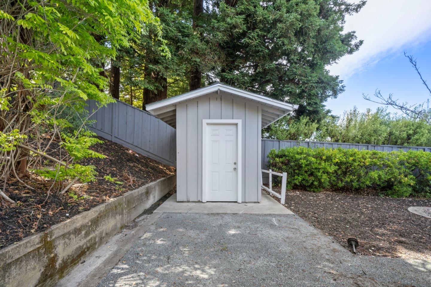 575 Darrell Road Hillsborough, CA 94010 - Photo 65 of 75 a front view of a house with a yard and garage