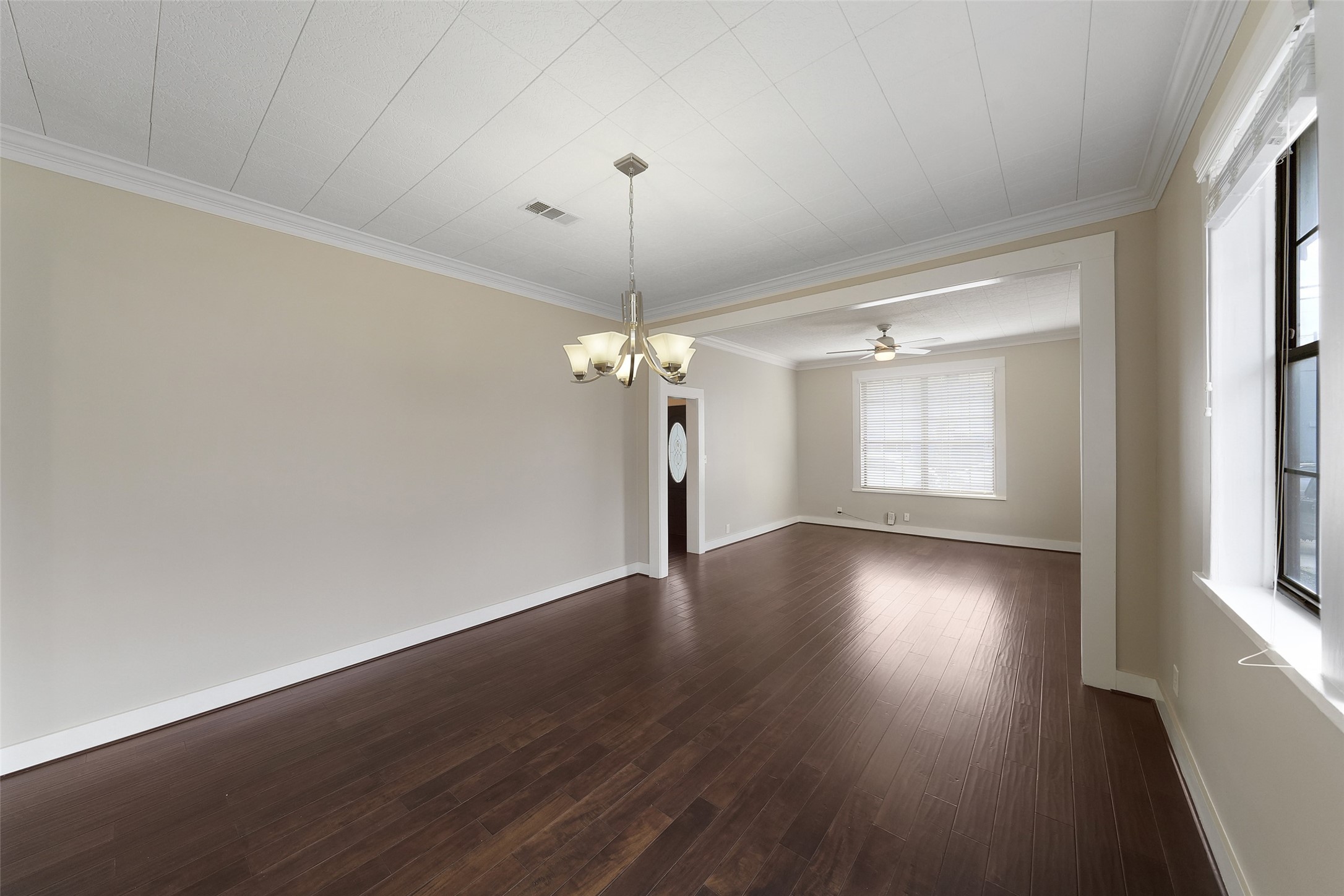 309 Pecore Street Houston, TX 77009 - Photo 26 of 45 a view of a room with wooden floor chandelier and windows