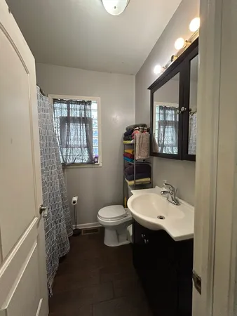 a bedroom with furniture and a wooden floor