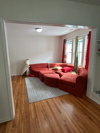 a living room with hard wood flooring and furniture