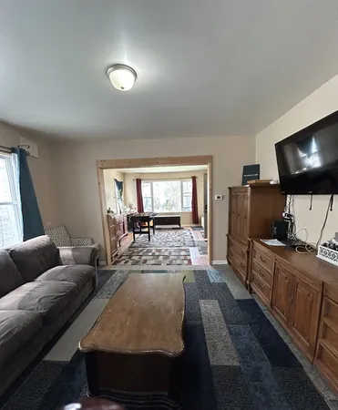 a living room with furniture and a rug